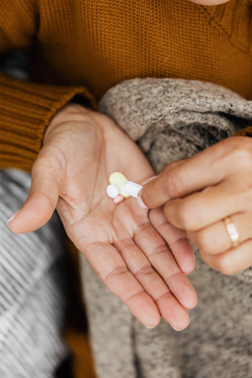 a close up shot of a person with medication on her hand