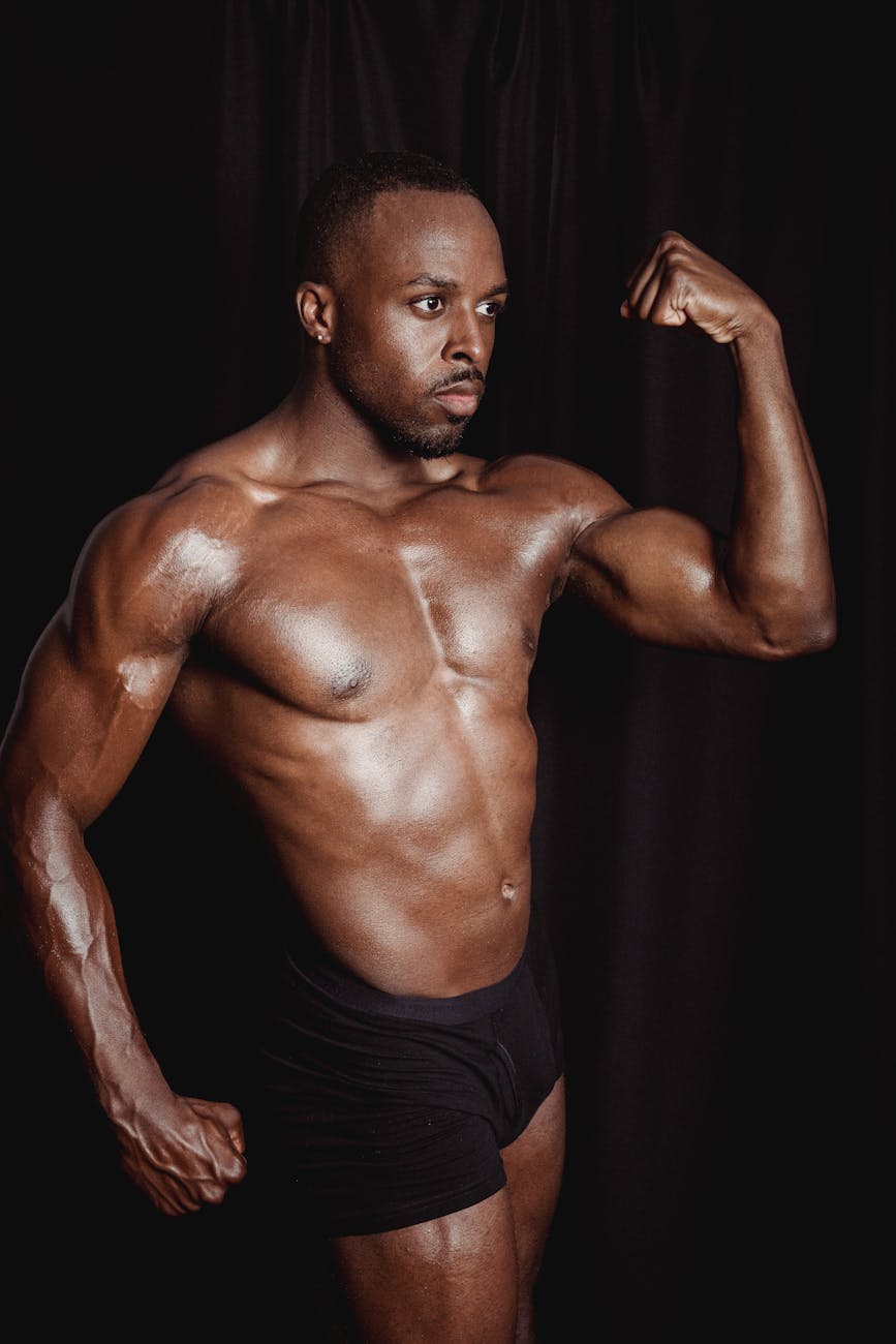 shirtless man flexing his muscles