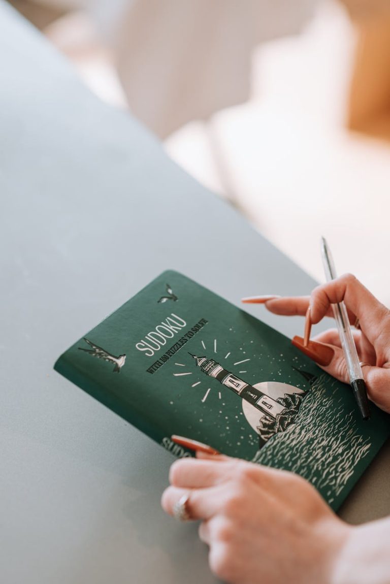 a person holding a sudoku book
